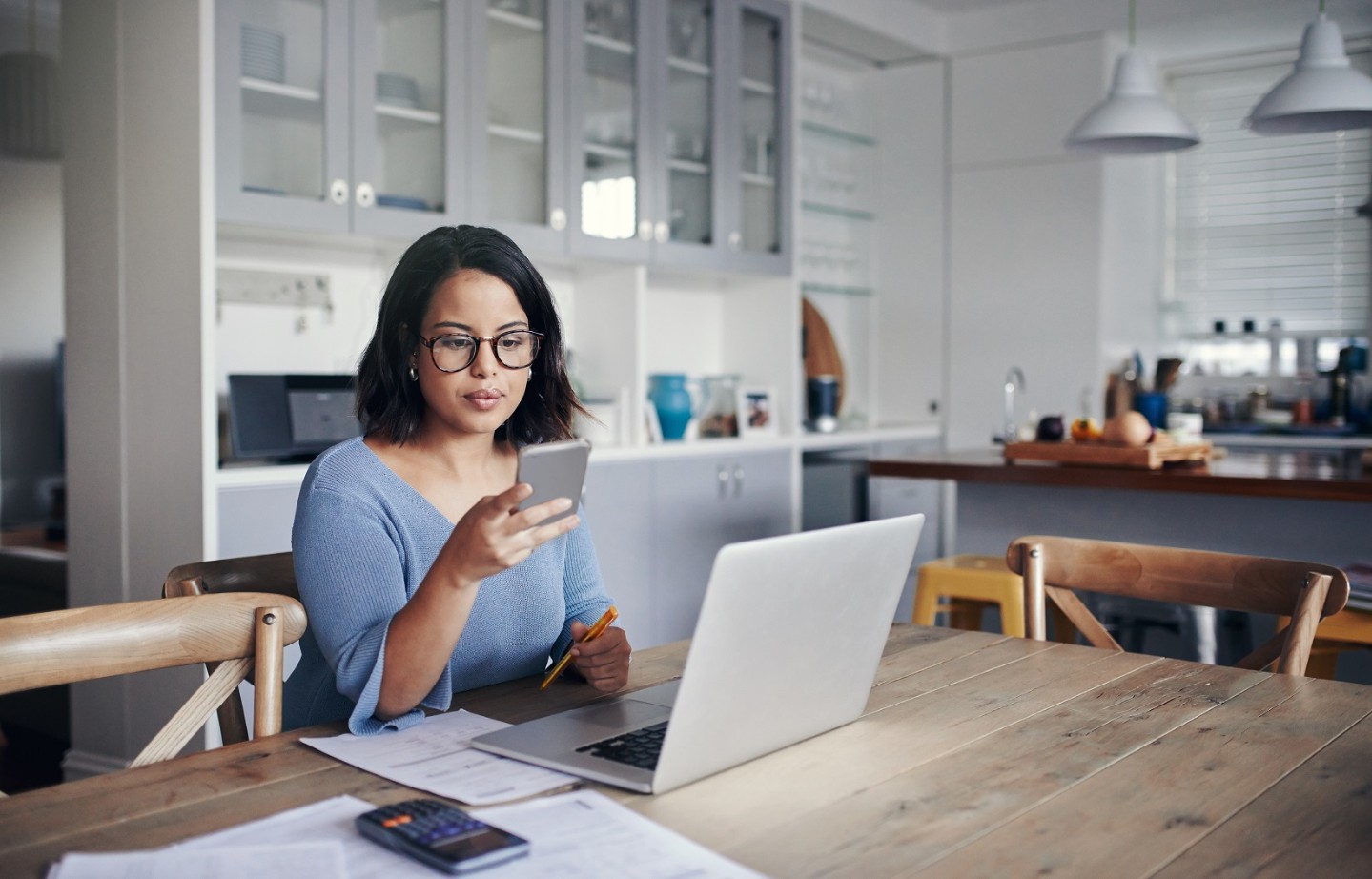 Women on her phone and viewing computer