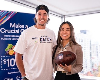 The Seattle Seahawks Jake Bobo Delivers a Game Ball to Virginia Mason Medical Center