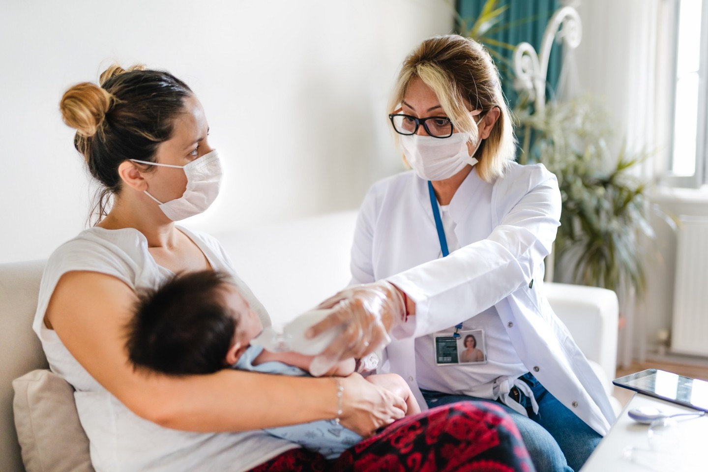 Nurse with mother and baby