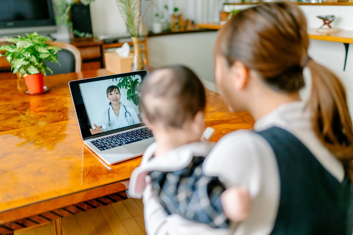 Mom and baby with doctor virtually