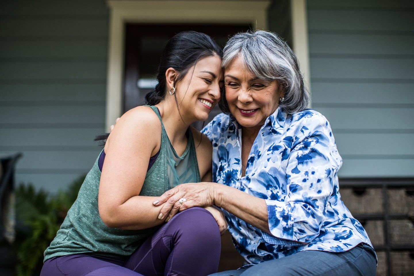 Two women smiling with heads together