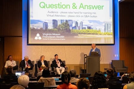 Neurosciences and Spine Symposium 2025 speaker at podium
